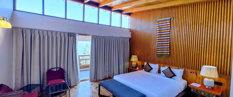 Timilo Royal Double — clerestory windows, pine beams and a balcony over the deodars