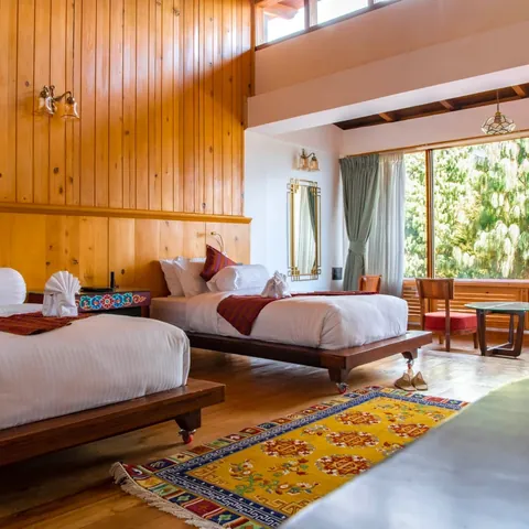 Timilo Royal Twin — picture windows onto the forest with Tibetan rugs underfoot