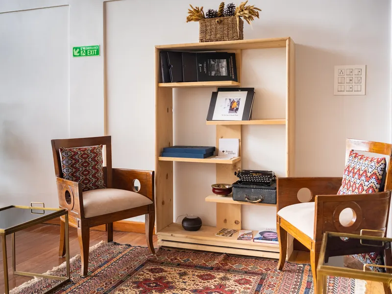 The reading corner with an old typewriter, bookshelves and cane armchairs