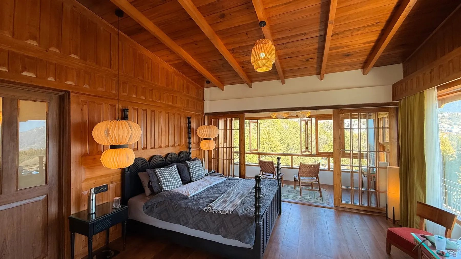 The Presidential Suite bedroom, paper lanterns low over the bed and windows on two sides