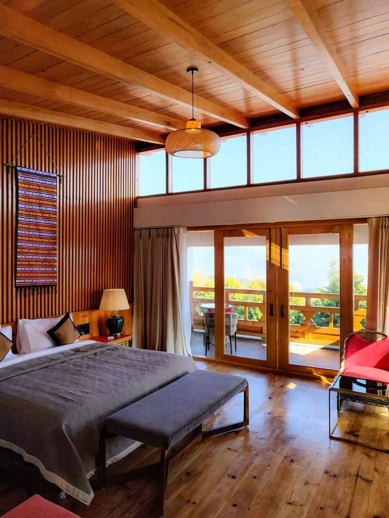Warm timber, and the balcony doors standing open — Timilo Royal Double, Timilo Boutique